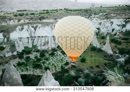 Hot Air Balloons Landing In A Mountain Cappadocia Goreme National Park Turkey.