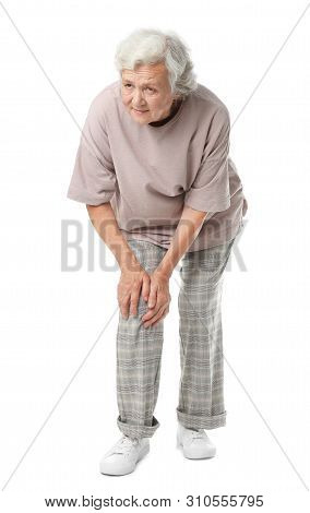 Full Length Portrait Of Senior Woman Having Knee Problems On White Background