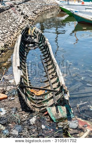 Makassar, Sulawesi, Indonesia - February 28, 2019: Paotere Old Port. Wrecked Skeleton Of Small Boat 