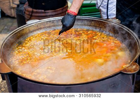 Cooking In A Large Cauldron Oriental Dishes - Soup Soup Large Vegetables And Meat. Shurpa In A Large
