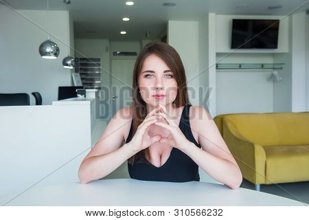 Close Up Portrait Of A Young Confident Serious Woman With Deep Decollete, Looking At The Camera, Hol