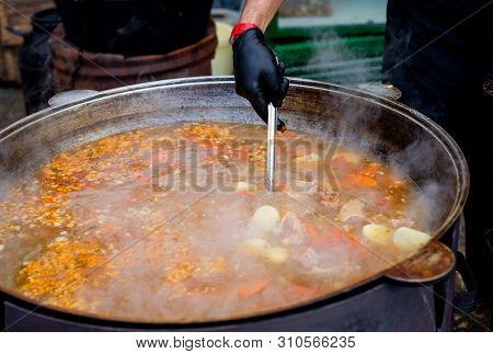 Cooking In A Large Cauldron Oriental Dishes - Soup Soup Large Vegetables And Meat. Shurpa In A Large