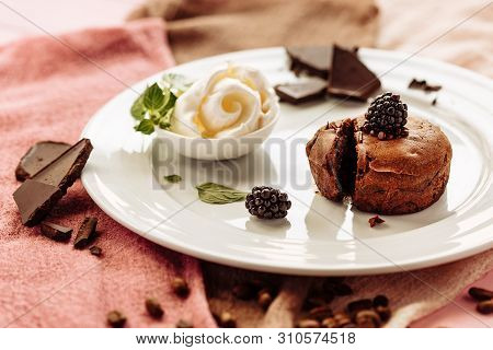 Chocolate Fondan With Syrup And Ice-cream On A Plate Decorated With Mint Leaves.