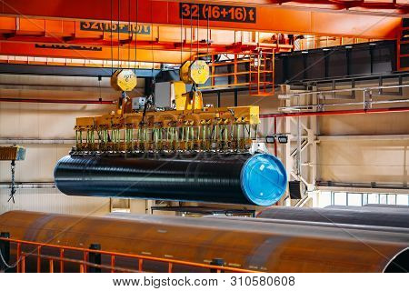 Coated Pipe Transportation By Overhead Crane With Vacuum Handling Grippers.