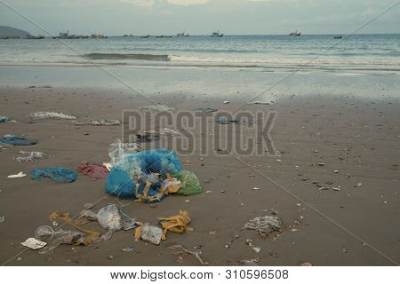 Trash, Plastic, Garbage, Bottle... Environmental Pollution On Sandy Beach. Royalty High-quality Stoc