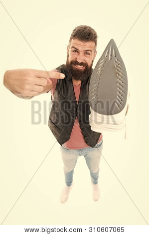 Household Ironing. Bearded Man Pointing At Clothes Iron. Hipster Presenting Electric Ironing Tool. U