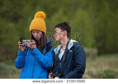 Asian Tourists Photographing With A Smart Phone