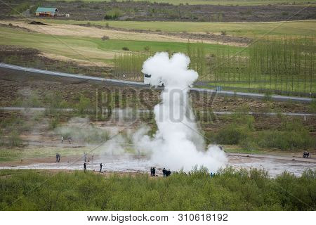 Tourists Visiting Strokkur Geyser In Iceland