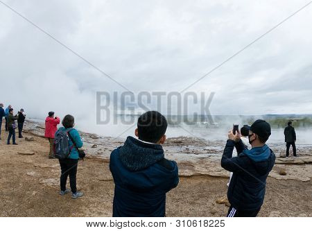 Strokkur Geyser, Iceland - May 20, 2019: Tourists Visiting And Waiting For The Eruption Of Strokkur 