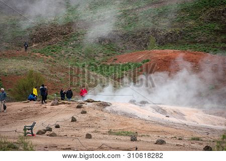 Tourists Visiting Strokkur Geyser In Iceland