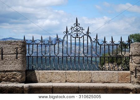 Ornate Iron Fence Panel On The New Bridge With Views Across The Spanish Countryside, Ronda, Malaga P