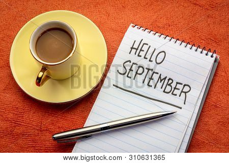 Hello September  - handwriting in a notebook with a cup of coffee
