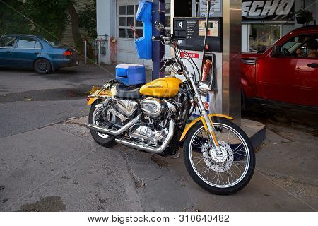 Montreal, Quebec, Canada, September 1, 2018. Harley Davidson Motorcycle Yellow Color At A Gas Statio