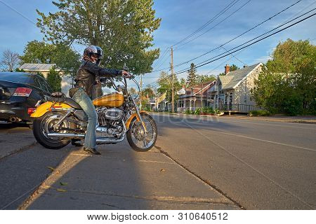Montreal, Quebec, Canada, September 1, 2018. Woman On A Yellow Harley Davidson Motorcycle. Moves Alo