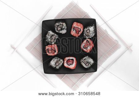 Different Types Of Maki Sushi On A Black Plate