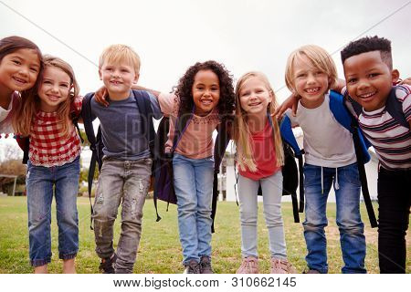 Portrait Of Excited Elementary School Pupils On Playing Field At Break Time