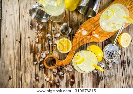 Trendy Summer Cold Drink. St Germain French Spritz Cocktail With Lemon Slices, Old Rustic Wooden Bac