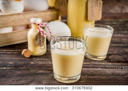 Traditional Italian Vov Eggs Liquor. German Egg Liqueur Eierlikor. In Different Bottle And Shot Glas