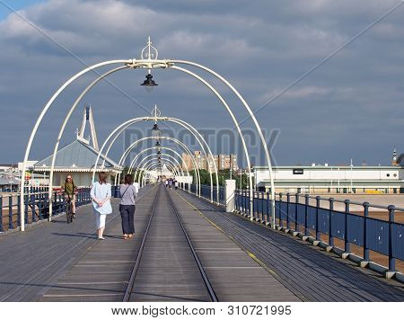 Southport, Merseyside, United Kingdom - 28 June 2019: People Walking Along Along The Pier In Southpo