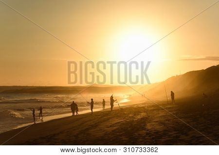 Family Fishing On A Sunset Afternoon Beach, Mossel Bay, South Africa