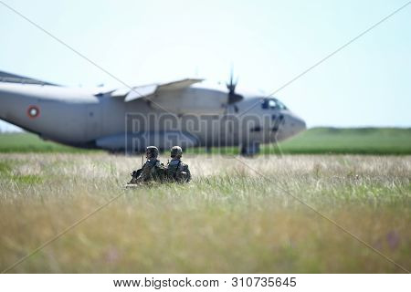 Boboc, Romania - May 22, 2019: Romanian Army Soldiers Patrol On A Military Air Base, With An Alenia 