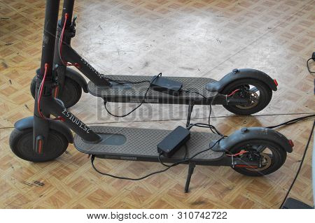 Two New Black Electronic Two-wheeled Fashionable Modern Fast Electric Scooters.