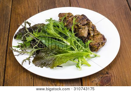 Slices Of Fried Liver, Green Leaves Of Salads