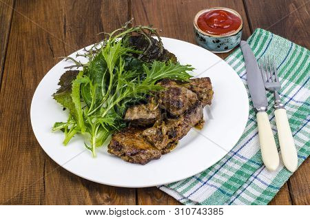 Slices Of Fried Liver, Green Leaves Of Salads