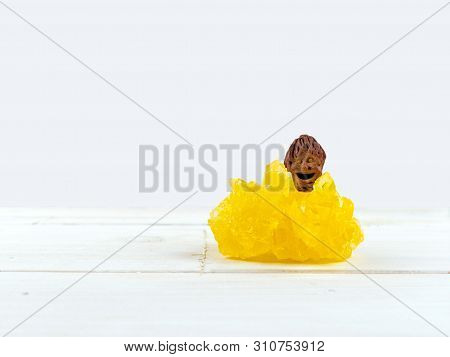 The Smiling Little Man, A Craft Piece, Talisman Graven From Peach Pit On A Big Yellow Sugar Crystal.