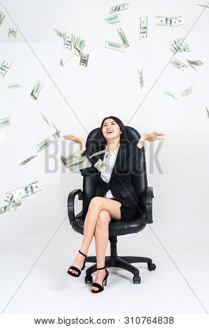 Portrait Young Asian Businesswoman Is Sitting On Boss Shair With  Happily About Many Flying Dollars 