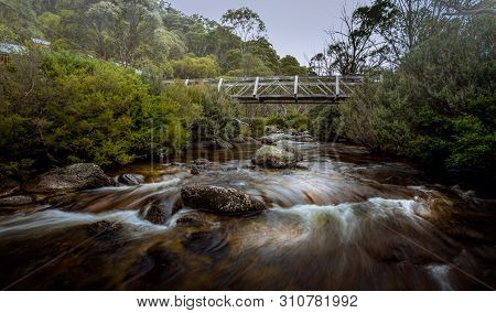 Footbridge Over Snowy River In The High Country Of Nsw Australia, The Rivers Entire Course Being Ove