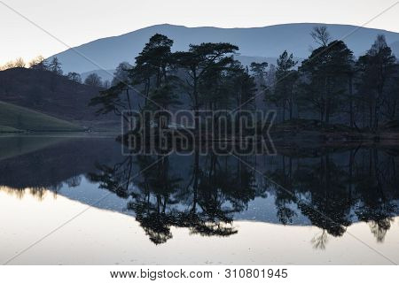Stunning Landscape Image Of Tarn Hows In Lake District During Beautiful Autumn Fall Evening Sunset W