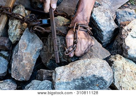 The Hands Of A Slave In An Attempt To Release. The Symbol Of Slave Labor. Hands In Chains.