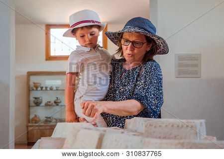 Grandmother Holding Grandson In His Arms. Traveling Concept. Tourism Background. Summer Vacation. Mo