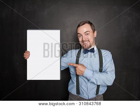 Handsome Smiling Man Showing On Empty Box In His Hand On Blackboard