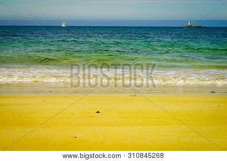Seascape Sandy Beach Sea Shore With Lighthouse On Horizon. Andoya Island Bleiksstranda Beach. Vester