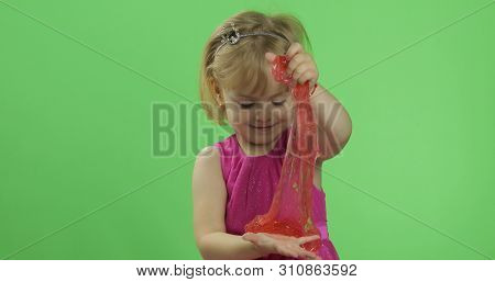 Child Having Fun Making Red Slime. Kid Playing With Hand Made Toy Slime. Funny Kid Girl. Relax And S