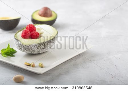 Homemade Organic Avocado And Pistacho Ice Cream With Raspberries