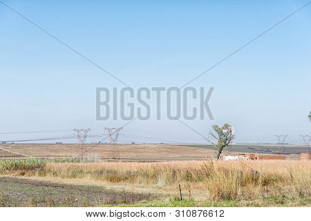 A Landscape, With A Windmill, Ruin And Power Route, Next To Road R38 Between Standerton And Bethal, 