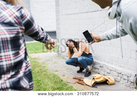 Partial View Of African American Boy And Teenager Pointing With Finger And Shooting Scared Teenager