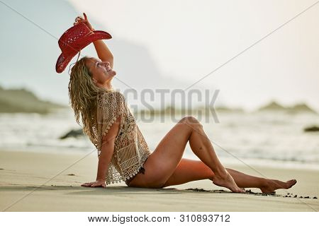 young woman relaxing on the beach in summer day