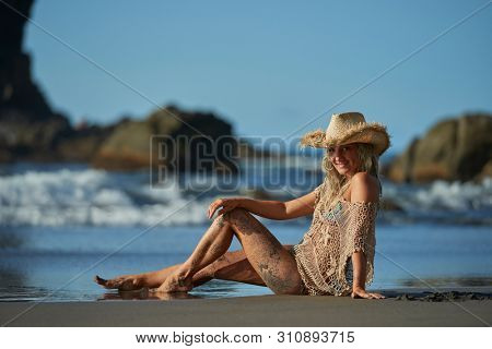 young woman relaxing on the beach in summer day