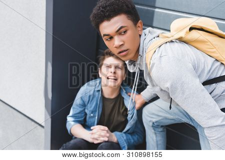 Selective Focus Of African American Boy In Hoodie And Jeans Bulling Screaming And Scared Boy