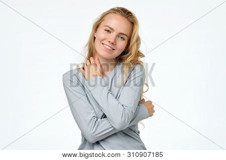 Happy Blonde Girl In Blue Pulover Smiling Looking At Camera