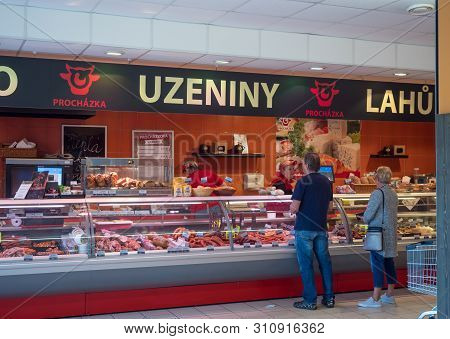 Cvikov, Czech Republic - May 24, 2019: Frontal View Of Butcher Shop In Penny Market With Female Butc