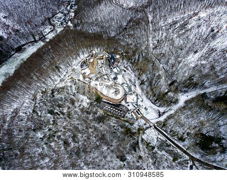 Aerial View Rock With Medieval Castle On It Near Moselle River In Brodenbach Winter With Forest Snow