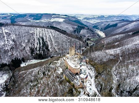 Aerial View Rock With Medieval Castle On It Near Moselle River In Brodenbach Winter With Forest Snow