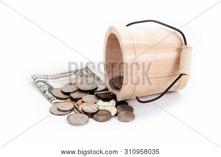 Wooden Bucket And Money, Us Dollars Bank Notes, Penny, Nickel, Dime, Quarter On A White Background. 