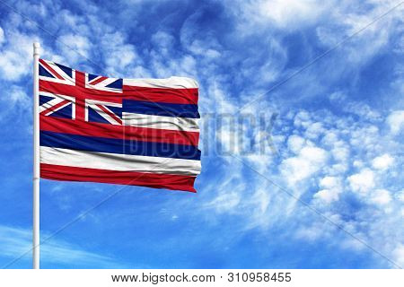 National Flag State Of Hawaii On A Flagpole In Front Of Blue Sky
