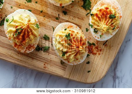 Stuffed Russian Deviled Eggs Topped With Parsley And Paprika
